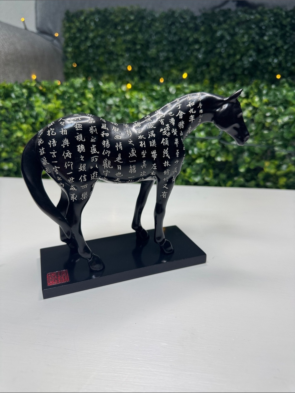 Black Ceramic Horse Sculpture with White Script Accent